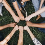 Diverse community with hands in a circle